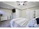 Spacious main bedroom featuring tray ceilings, ceiling fan, recessed lights, and a built-in television at 701 Monticello Ln, Mcdonough, GA 30253