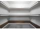 Walk-in pantry with custom shelving to maximize storage, allowing for organization in the kitchen at 701 Monticello Ln, Mcdonough, GA 30253