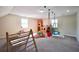 Spacious playroom features carpet, swings, play structure, ladder, and multiple play areas at 701 Monticello Ln, Mcdonough, GA 30253
