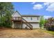 Backyard view of home featuring a deck with stairs and gray siding at 7832 Cambridge Dr, Douglasville, GA 30134