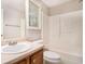Bathroom featuring a shower-tub combination, wooden vanity, and bright lighting at 7832 Cambridge Dr, Douglasville, GA 30134