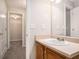 Bathroom with a wooden vanity, and doorway to a walk-in closet at 7832 Cambridge Dr, Douglasville, GA 30134