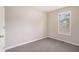 Cozy bedroom with neutral carpet, a large window with blinds, and neutral walls at 7832 Cambridge Dr, Douglasville, GA 30134