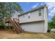 Exterior view of two-story home with light gray siding, elevated deck, and stairway at 7832 Cambridge Dr, Douglasville, GA 30134