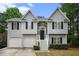 Charming two-story home featuring gray siding, stone accents, and a two-car garage at 7832 Cambridge Dr, Douglasville, GA 30134