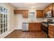 Kitchen featuring stainless steel appliances, wood cabinets, a stainless steel sink and hardwood floors at 7832 Cambridge Dr, Douglasville, GA 30134