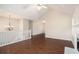 Open concept living room featuring vaulted ceilings, hardwood floors, and a ceiling fan at 7832 Cambridge Dr, Douglasville, GA 30134