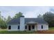 Rear exterior view showcasing modern siding, a covered porch, and a classic chimney at 877 Highway 101 N, Dallas, GA 30157
