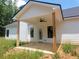 Backyard featuring a covered porch with wood posts and ceiling fan at 877 Highway 101 N, Dallas, GA 30157