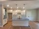 Bright kitchen boasts an island, white cabinets, and modern pendant lighting at 877 Highway 101 N, Dallas, GA 30157