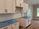 A new kitchen featuring white cabinets, black hardware, and granite countertops at 877 Highway 101 N, Dallas, GA 30157