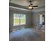 Main bedroom features a tray ceiling, ceiling fan, and large window providing ample natural light at 877 Highway 101 N, Dallas, GA 30157