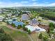 Aerial view of the community center featuring a pool, tennis courts, parking and a lush green landscape at 1237 Park Pass Way, Suwanee, GA 30024