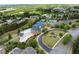 High angle view featuring the community pool, tennis courts, clubhouse, and lush landscaping at 1237 Park Pass Way, Suwanee, GA 30024