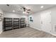 This finished basement features shelving and a ceiling fan at 1237 Park Pass Way, Suwanee, GA 30024
