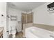 A well-lit bathroom featuring modern fixtures and combined shower and tub at 1237 Park Pass Way, Suwanee, GA 30024