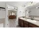 Bathroom boasts double sinks, a large mirror, and a glimpse into the main bedroom at 1237 Park Pass Way, Suwanee, GA 30024