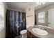 This bathroom has a shower and tub combination, a sink, and a toilet at 1237 Park Pass Way, Suwanee, GA 30024