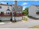 Exterior of the townhome featuring an attached garage and a private balcony, with grassy common areas at 1237 Park Pass Way, Suwanee, GA 30024