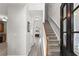 Inviting foyer with hardwood floors, staircase, and views into the kitchen and living room at 1237 Park Pass Way, Suwanee, GA 30024