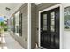 Close-up of the front door and covered porch with gray siding and white trim at 1237 Park Pass Way, Suwanee, GA 30024