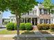 Charming two-story house featuring a covered porch, black shutters, and manicured bushes in the front yard at 1237 Park Pass Way, Suwanee, GA 30024