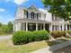 Inviting two-story home with a covered front porch, black shutters, and beautiful landscaping at 1237 Park Pass Way, Suwanee, GA 30024