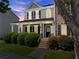 Charming two-story home with a welcoming front porch, manicured bushes, and a well-maintained lawn at 1237 Park Pass Way, Suwanee, GA 30024