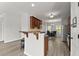 Open-concept kitchen featuring a breakfast bar and stainless appliances, with views to the dining area at 1237 Park Pass Way, Suwanee, GA 30024