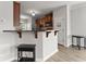 Open-concept kitchen featuring a breakfast bar with views to the dining area at 1237 Park Pass Way, Suwanee, GA 30024