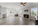 Spacious living room with fireplace, ceiling fan, hardwood floors and bright windows at 1237 Park Pass Way, Suwanee, GA 30024
