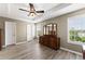 Primary bedroom with tray ceiling, hardwood floors and abundant light at 1237 Park Pass Way, Suwanee, GA 30024