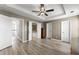Large primary bedroom featuring hardwood floors, ensuite bathroom and bright windows at 1237 Park Pass Way, Suwanee, GA 30024