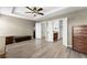 Spacious main bedroom features a tray ceiling, ceiling fan and en suite bathroom at 1237 Park Pass Way, Suwanee, GA 30024