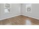 Well-lit bedroom featuring hardwood floors and two windows for natural light at 2811 Mango Nw Cir, Atlanta, GA 30318