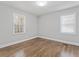 Well-lit bedroom featuring hardwood floors and two windows for natural light at 2811 Mango Nw Cir, Atlanta, GA 30318