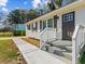 Close-up of the home's entrance, showcasing the fresh gray paint and white trim of the covered porch at 2811 Mango Nw Cir, Atlanta, GA 30318