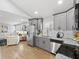 Open kitchen features stainless steel appliances, gray cabinets, and marble countertops at 2811 Mango Nw Cir, Atlanta, GA 30318