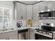 Bright updated kitchen with stainless appliances, gray cabinets and marble backsplash at 2811 Mango Nw Cir, Atlanta, GA 30318