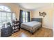 Bright bedroom featuring wood floors and a large window that provides natural light at 4319 Silver Peak Pkwy, Suwanee, GA 30024