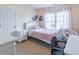 Cozy bedroom with white furniture, a comfortable bed, and plenty of natural light at 4319 Silver Peak Pkwy, Suwanee, GA 30024