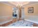 Elegant dining room with hardwood floors, chandelier, and large window bringing in natural light at 4319 Silver Peak Pkwy, Suwanee, GA 30024