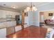 Bright dining room showcasing a wood table with chairs, stainless appliances, and access to living spaces at 4319 Silver Peak Pkwy, Suwanee, GA 30024