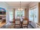 Bright dining room with large windows, stylish curtains, wood table with chairs, and outdoor access at 4319 Silver Peak Pkwy, Suwanee, GA 30024