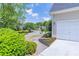 A concrete driveway leads up to a home featuring manicured landscaping in a desirable neighborhood at 4319 Silver Peak Pkwy, Suwanee, GA 30024