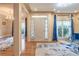 Elegant foyer with hardwood floors, chandelier, and views into the living and dining areas at 4319 Silver Peak Pkwy, Suwanee, GA 30024