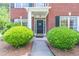 Inviting front door with wreath, flanked by manicured bushes on a neatly maintained lawn at 4319 Silver Peak Pkwy, Suwanee, GA 30024