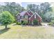 Charming red brick home featuring a well-manicured lawn and beautiful landscaping in a desirable community at 4319 Silver Peak Pkwy, Suwanee, GA 30024