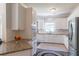 Bright eat-in kitchen with granite counters, white cabinetry, stainless appliances, and tile backsplash at 4319 Silver Peak Pkwy, Suwanee, GA 30024