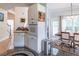 Eat-in kitchen showcasing stainless steel appliances, breakfast area and granite countertops adjacent to a cozy living space at 4319 Silver Peak Pkwy, Suwanee, GA 30024